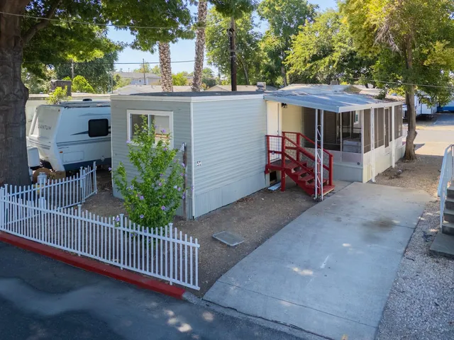 a view of a house with a yard and sitting area
