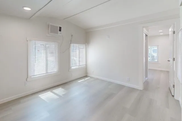 an empty room with windows and closet