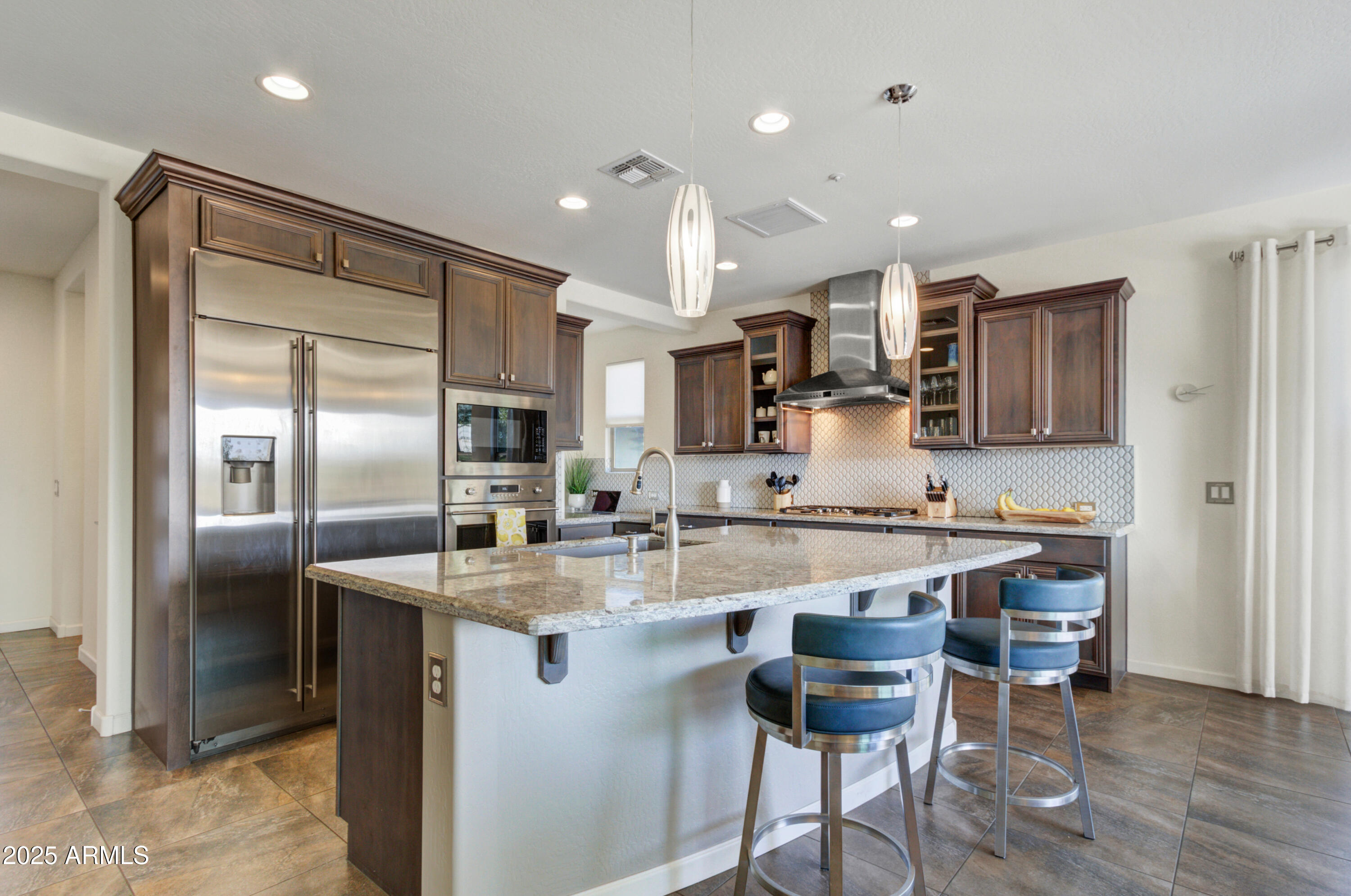 17919 East Slide Rock Drive Rio Verde, AZ 85263 - Photo 11 of 48 a kitchen with stainless steel appliances granite countertop a refrigerator and a stove top oven