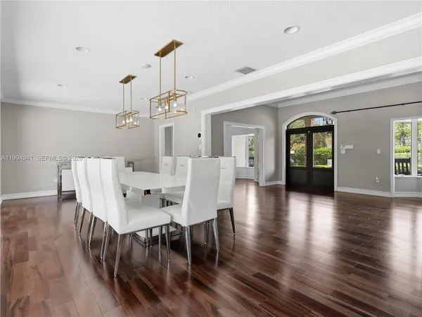a view of a dining room with furniture and wooden floor