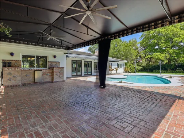 an aerial view of a house with garden space and street view