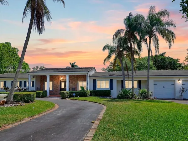 a view of a chairs and table in patio with a yard