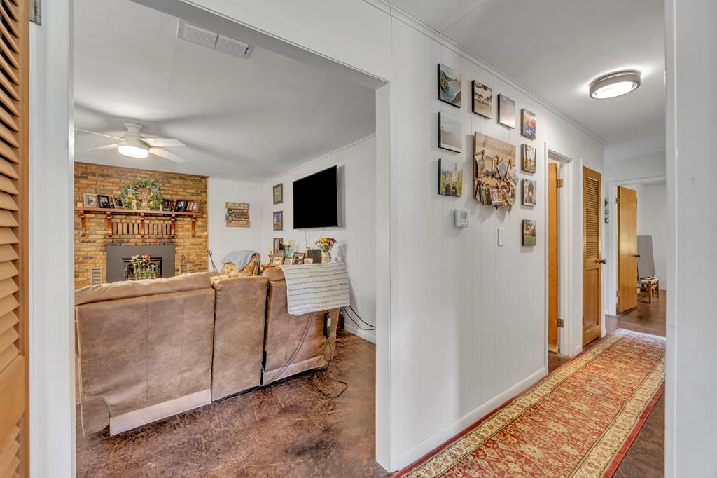 9822 Nasturtium Road Ore City, TX 75683 - Photo 18 of 37 a living room with furniture and a flat screen tv