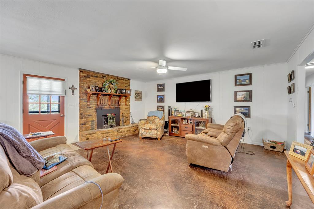 9822 Nasturtium Road Ore City, TX 75683 - Photo 19 of 37 a living room with furniture and a flat screen tv