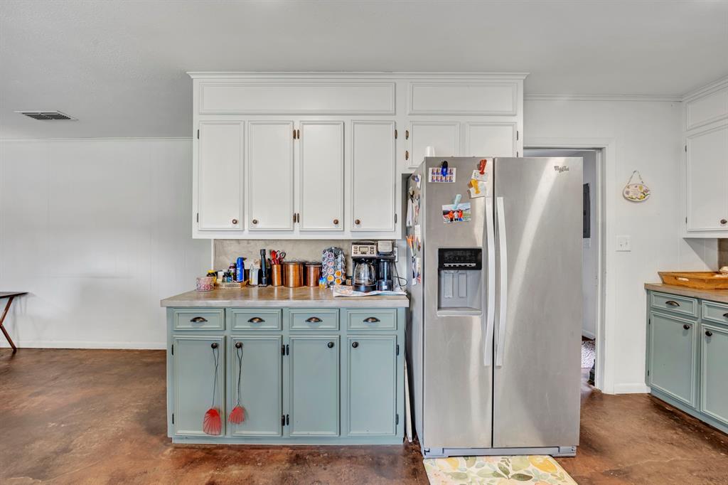 9822 Nasturtium Road Ore City, TX 75683 - Photo 25 of 37 a kitchen with stainless steel appliances a refrigerator and a cabinets
