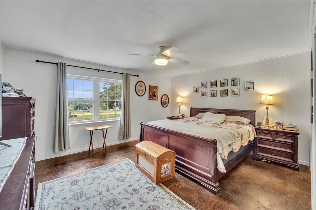 9822 Nasturtium Road Ore City, TX 75683 - Photo 26 of 37 a bed sitting in a bedroom next to a window