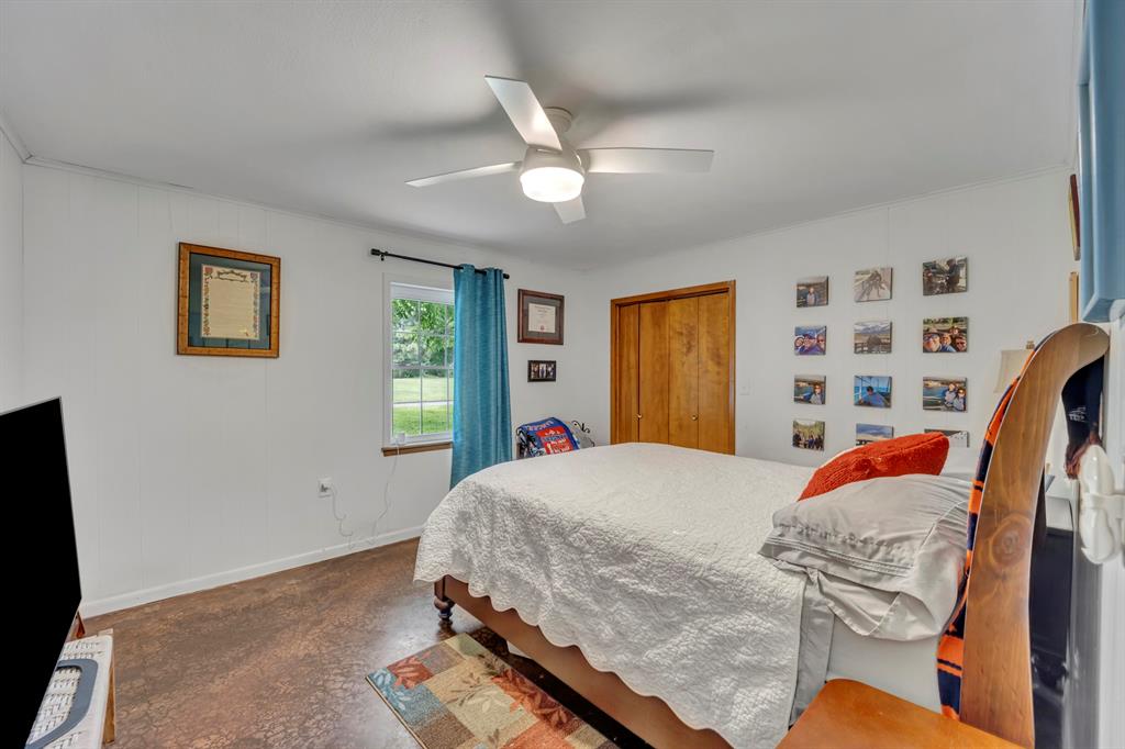 9822 Nasturtium Road Ore City, TX 75683 - Photo 29 of 37 a bedroom with bed and a window