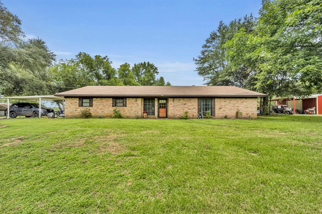 9822 Nasturtium Road Ore City, TX 75683 - Photo 3 of 37 front view of a house with a yard