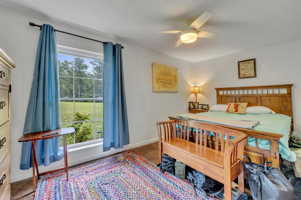 9822 Nasturtium Road Ore City, TX 75683 - Photo 31 of 37 a bedroom with furniture and a window