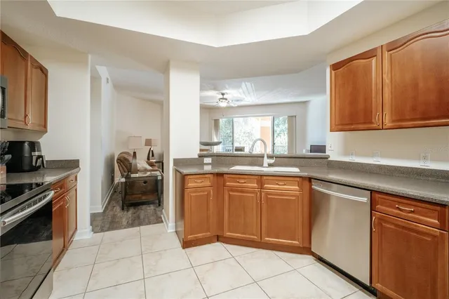 a kitchen with stainless steel appliances granite countertop a sink and cabinets