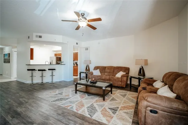 a living room with furniture and kitchen view