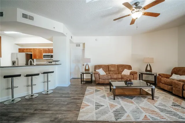 a living room with furniture and a wooden floor