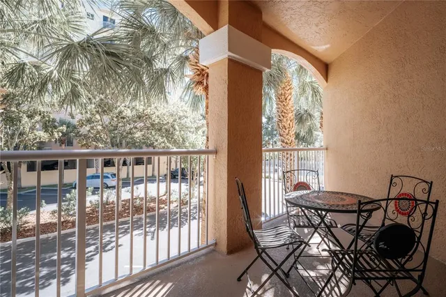 a view of a chairs and table in the balcony