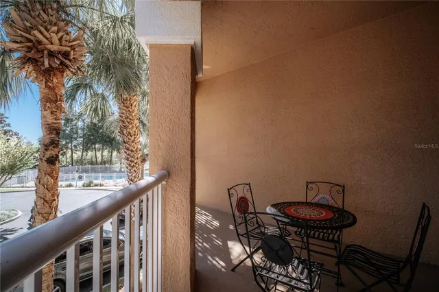 a view of a balcony with a table and chairs