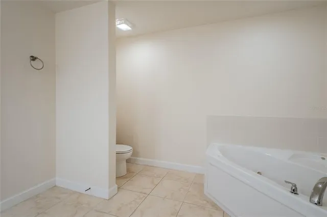 a bathroom with a bathtub and toilet