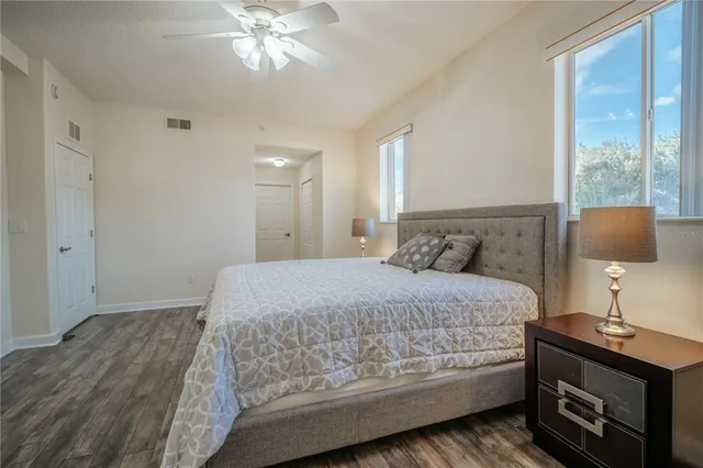 a bedroom with a bed and a lamp