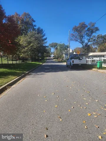 a view of a house with a yard and basketball court