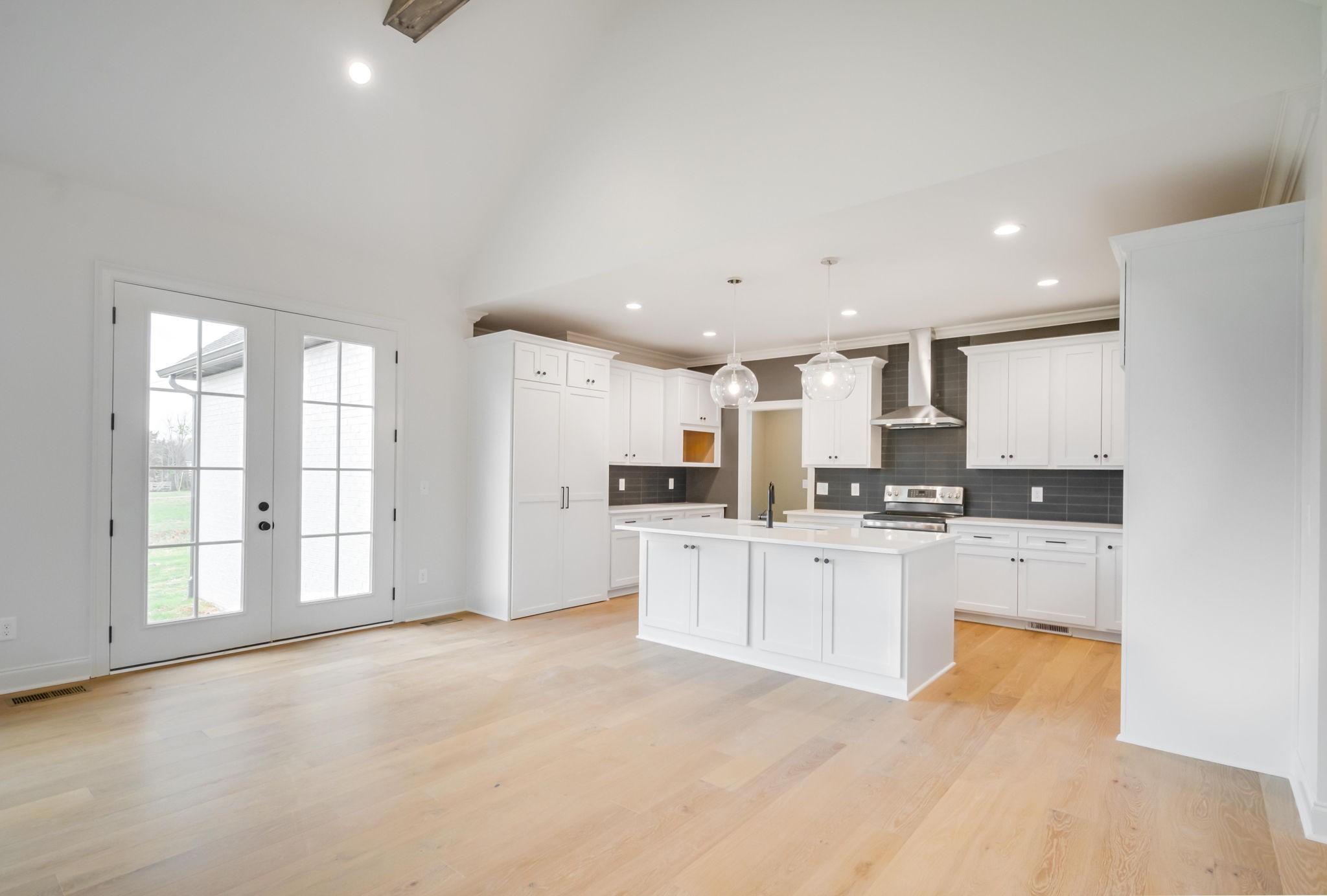 2235 Alvin Head Road Springfield, TN 37172 - Photo 7 of 31 a large white kitchen with stainless steel appliances granite countertop a stove a sink a refrigerator and white cabinets with wooden floor