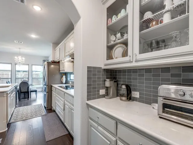 a kitchen with appliances cabinets and a table