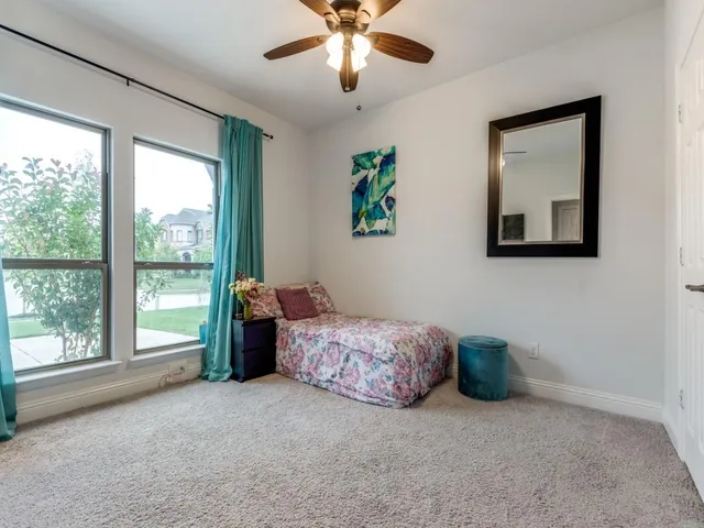 a living room with a bed furniture and a large window