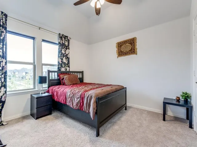 a spacious bedroom with a bed and a window