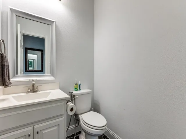 a bathroom with a toilet a sink and mirror