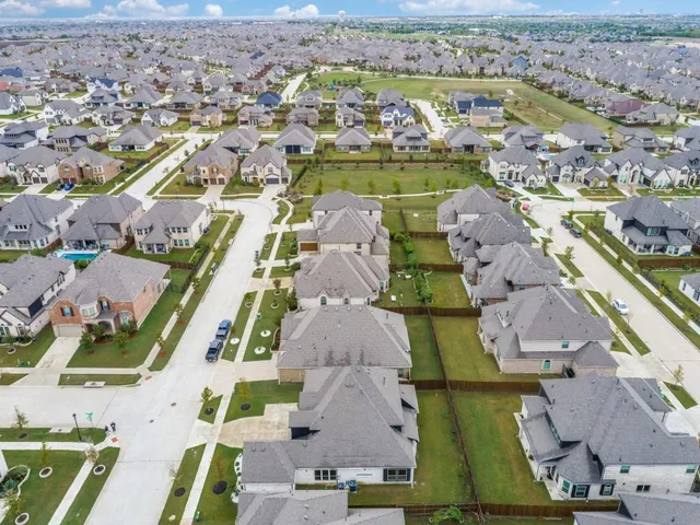 an aerial view of residential houses with outdoor space