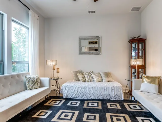 a living room with furniture a rug and a large window