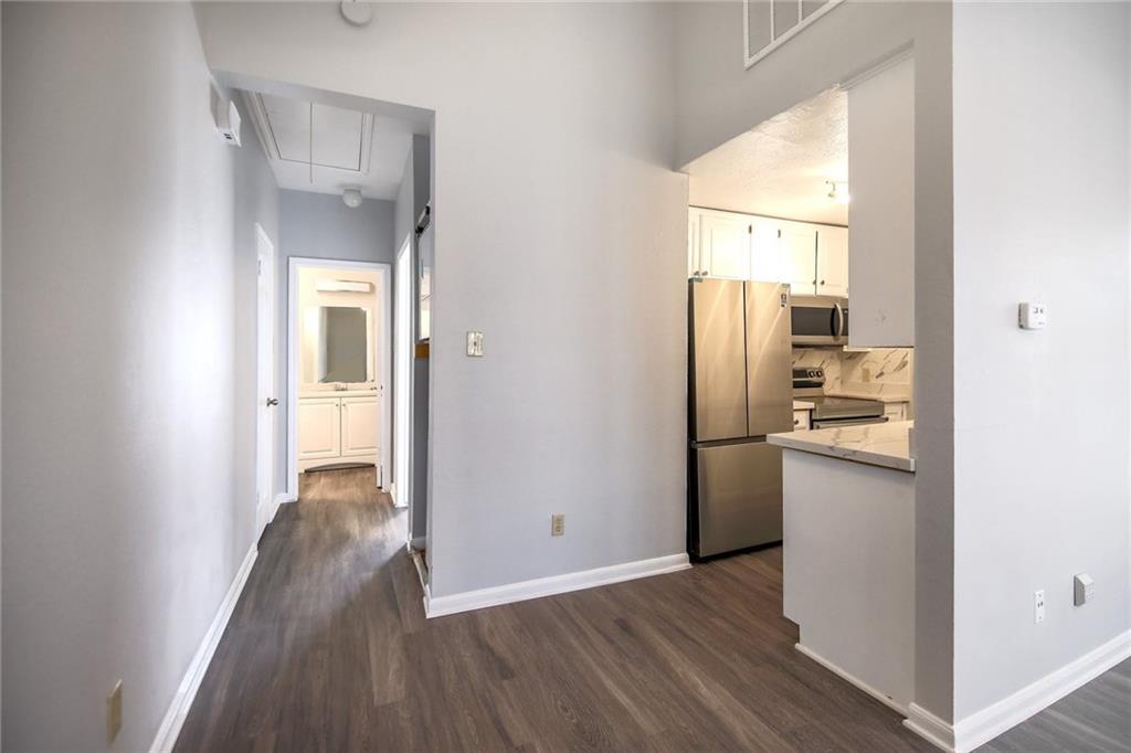 2529 Rio Grande Street, Unit 93 Austin, TX 78705 - Photo 15 of 19 a kitchen with a refrigerator and a wooden floor