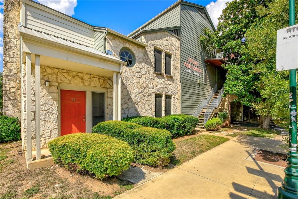 2529 Rio Grande Street, Unit 93 Austin, TX 78705 - Photo 19 of 19 a front view of a house with a yard