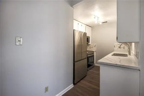 a kitchen with a refrigerator and a sink