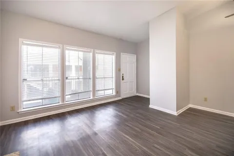 a view of a room with wooden floor