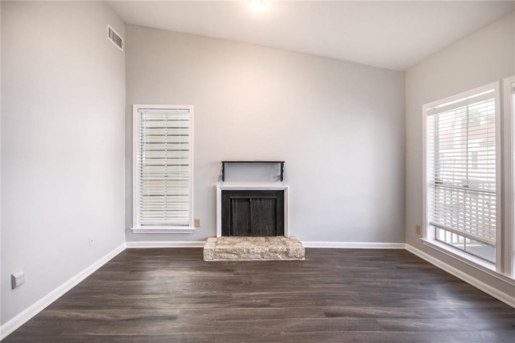 2529 Rio Grande Street, Unit 93 Austin, TX 78705 - Photo 9 of 19 a view of an empty room with wooden floor fireplace and a window