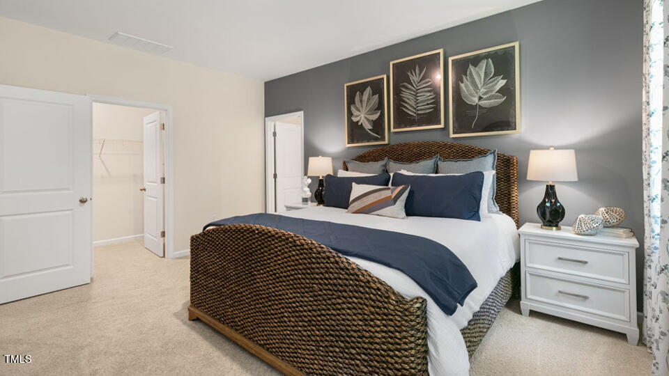 1220 Pavo Path Wendell, NC 27591 - Photo 11 of 26 a bedroom with a bed and a lamp on dresser