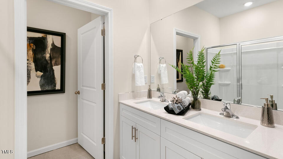 1220 Pavo Path Wendell, NC 27591 - Photo 12 of 26 a bathroom with sink and mirror