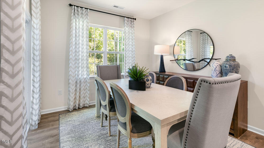 1220 Pavo Path Wendell, NC 27591 - Photo 6 of 26 a view of a dining room with furniture and a potted plant