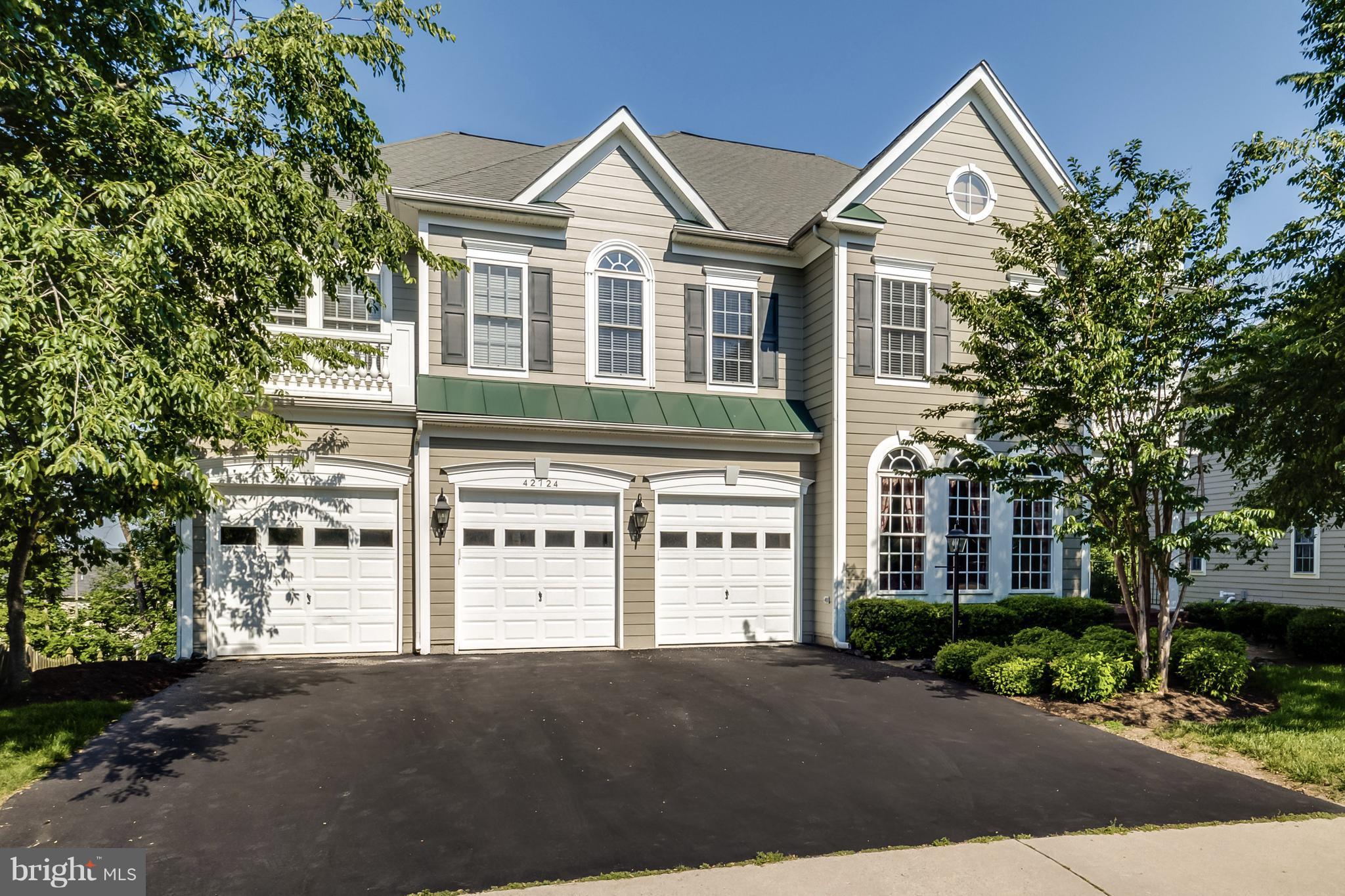 42724 Ridgeway Drive Broadlands, VA 20148 - Photo 1 of 30 a view of a white house next to a road and trees