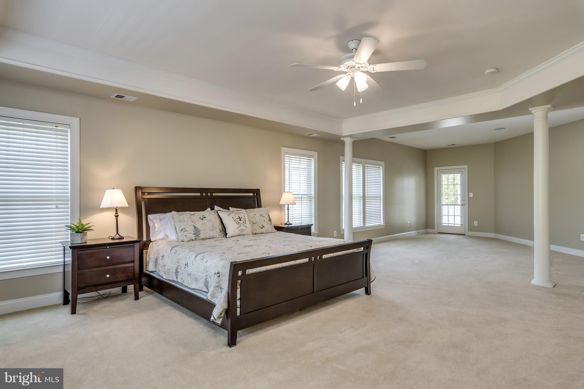 42724 Ridgeway Drive Broadlands, VA 20148 - Photo 15 of 30 a spacious bedroom with a bed and a chandelier