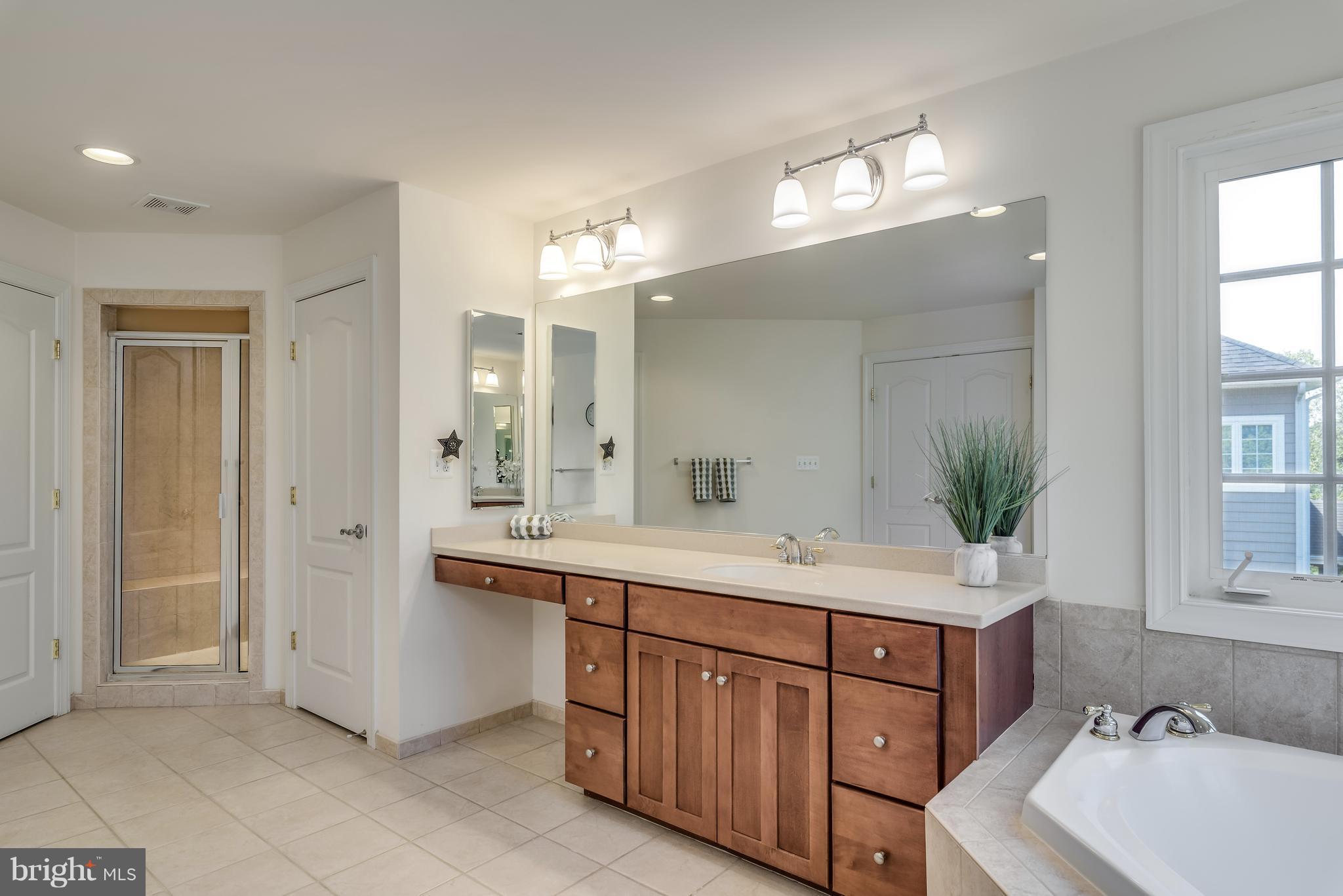 42724 Ridgeway Drive Broadlands, VA 20148 - Photo 17 of 30 a bathroom with a sink double vanity granite tub and a mirror