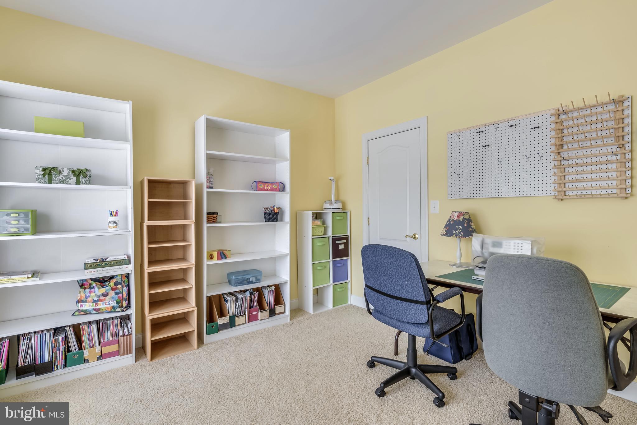 42724 Ridgeway Drive Broadlands, VA 20148 - Photo 23 of 30 a view of a workspace with furniture and a bookshelf