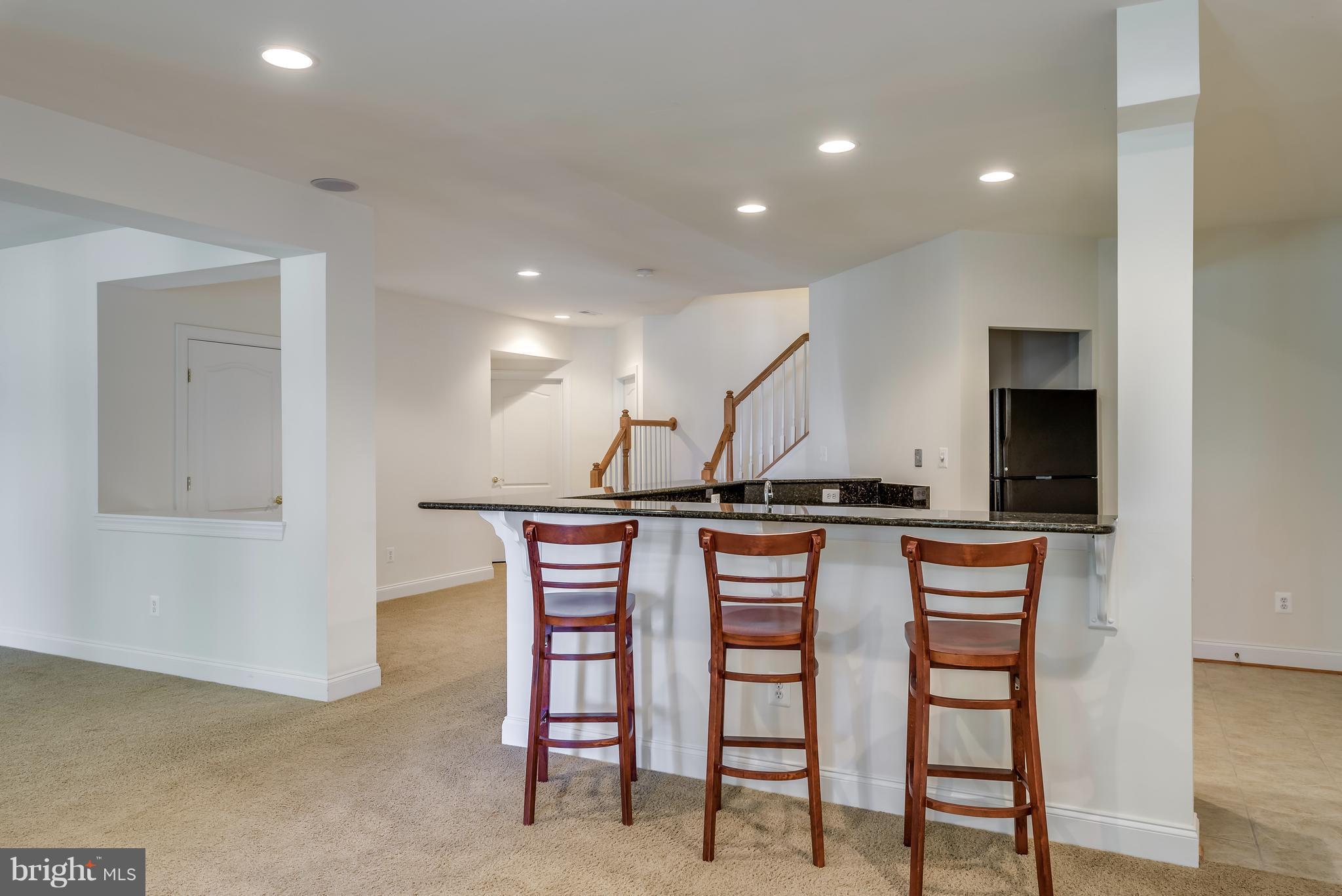 42724 Ridgeway Drive Broadlands, VA 20148 - Photo 24 of 30 a kitchen with stainless steel appliances a sink stove and cabinets