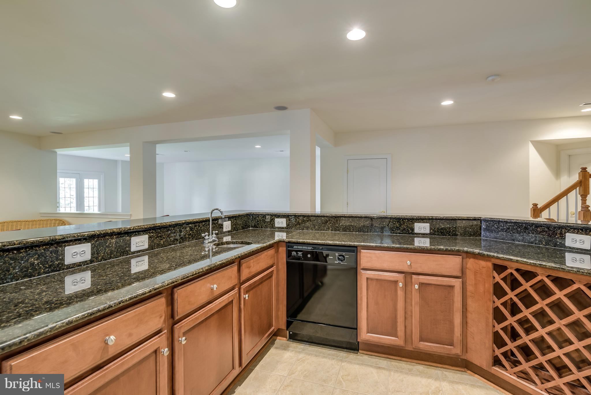 42724 Ridgeway Drive Broadlands, VA 20148 - Photo 25 of 30 a kitchen with granite countertop sink stove and cabinets