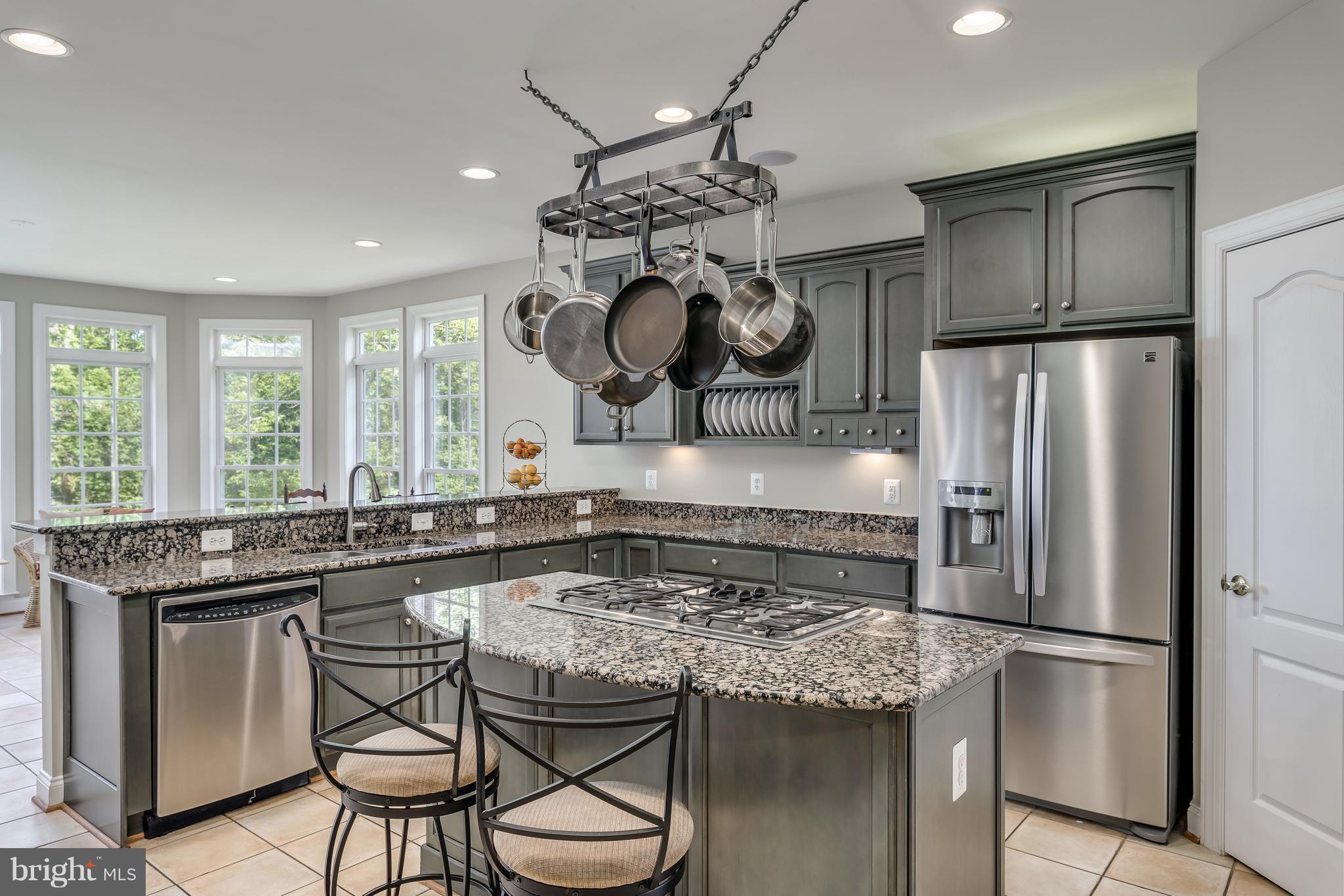 42724 Ridgeway Drive Broadlands, VA 20148 - Photo 6 of 30 a kitchen with stainless steel appliances granite countertop a sink a stove and a refrigerator