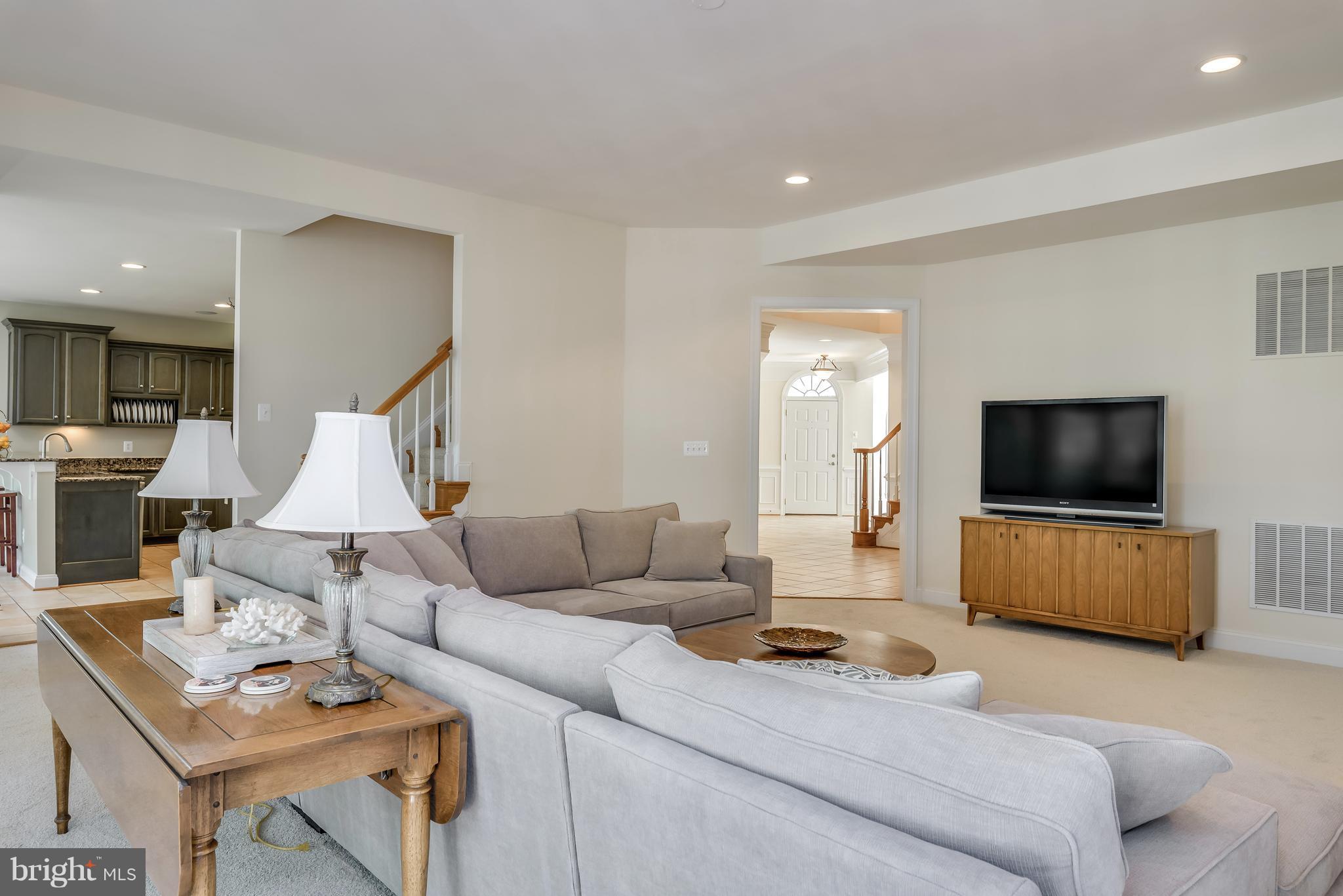 42724 Ridgeway Drive Broadlands, VA 20148 - Photo 9 of 30 a living room with furniture and a flat screen tv