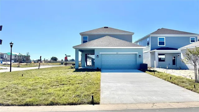 a view of a house with swimming pool and sitting area