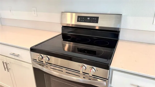 a stove top oven sitting inside of a kitchen