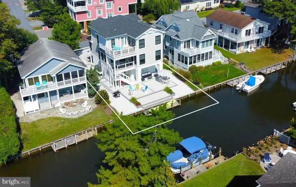 an aerial view of multiple houses with yard