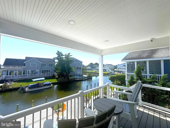 a view of a chair and tables in the balcony