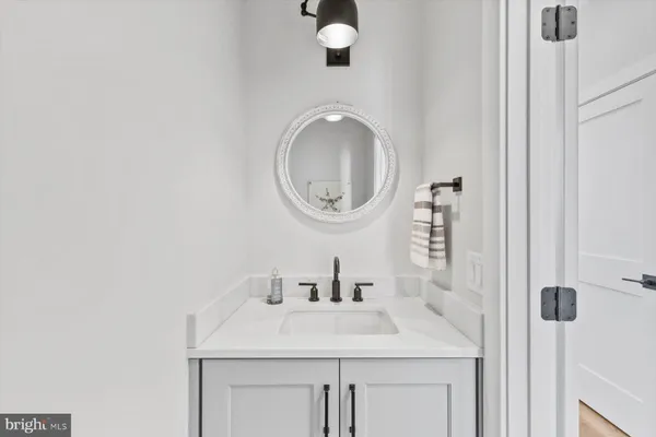 a bathroom with a sink vanity and a mirror