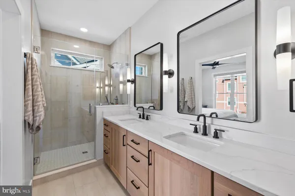 a bathroom with double vanity and a shower